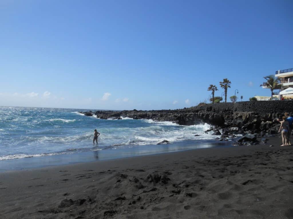 couple traveling to a romantic volcanic beach at Tenerife, Canary Islands
